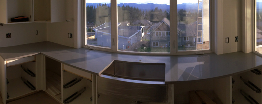 Quartz kitchen with stainless steel apron sink